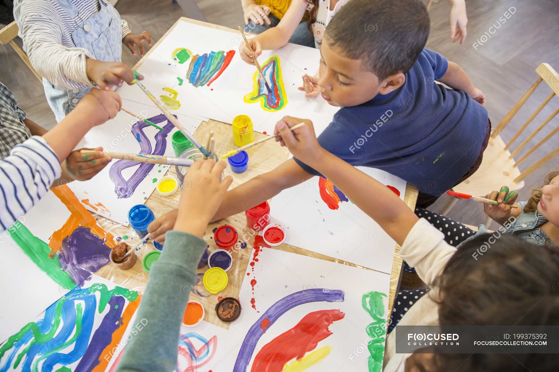 Children painting in class indoors — table, inspiration Stock Photo