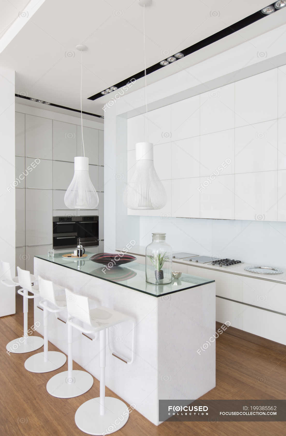 Bar stools at counter in modern kitchen — simplicity, tranquility