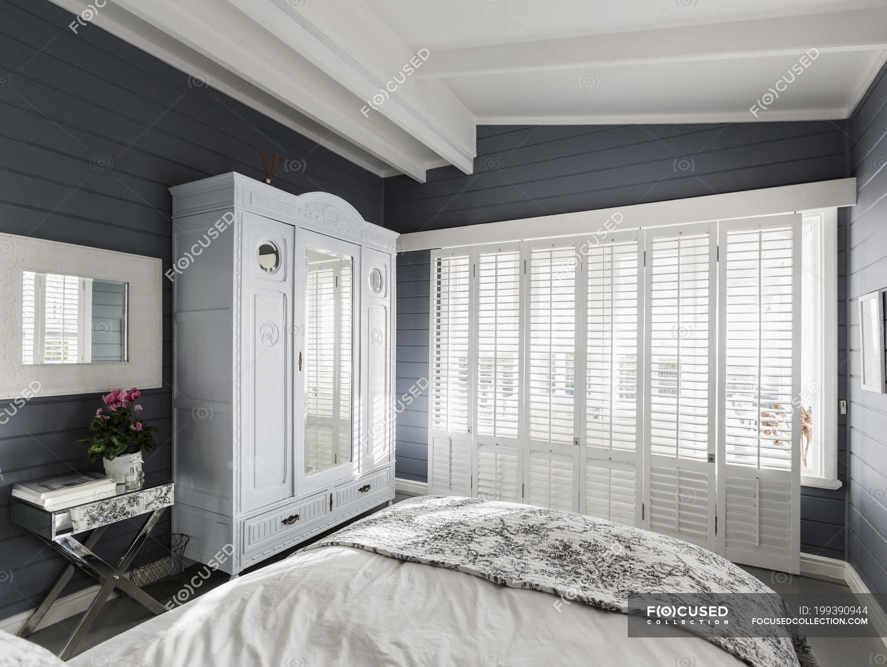 Luxury Home Showcase Bedroom With White Wood Shutters And Vaulted