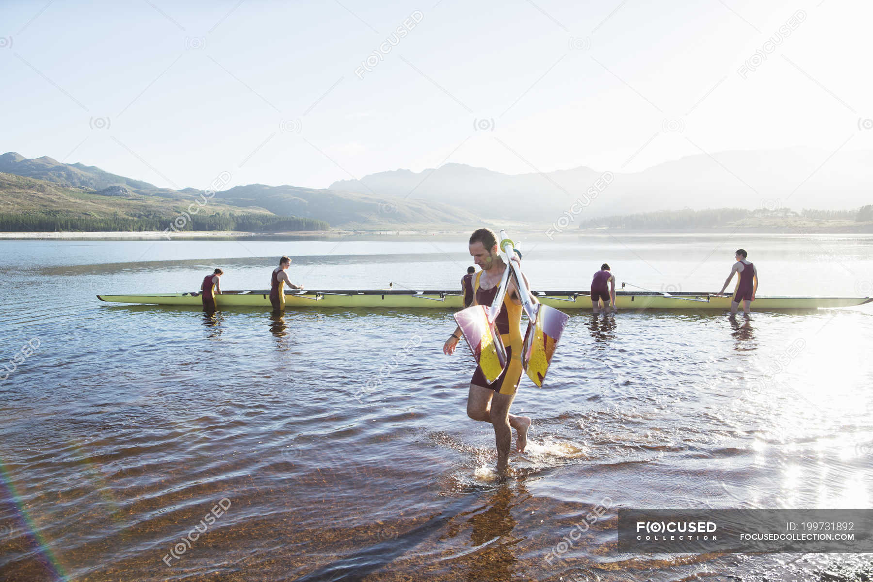 Rowing team with oars and scull on lake — competition, Medium Group Of People Stock Photo