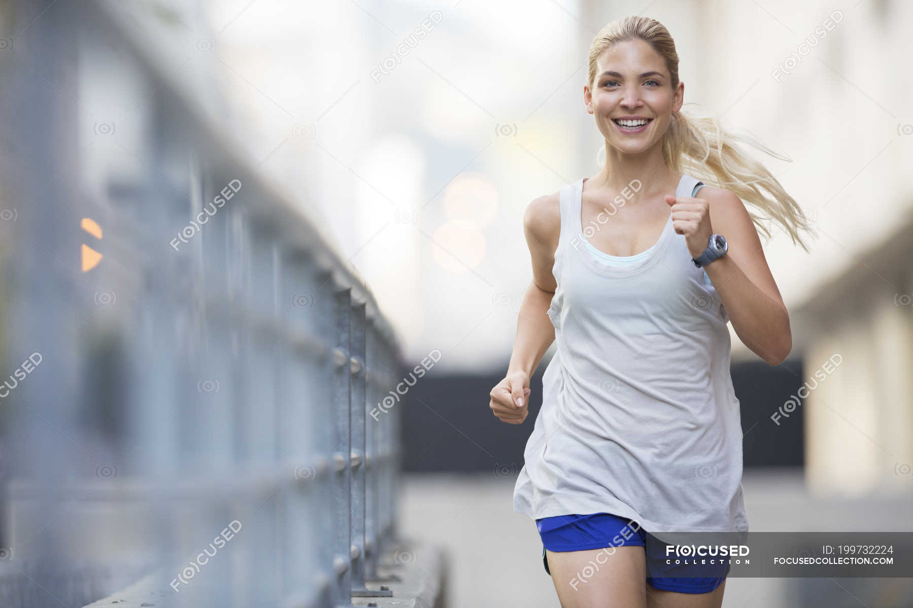 Woman running through city streets — Color Image, copy space - Stock ...