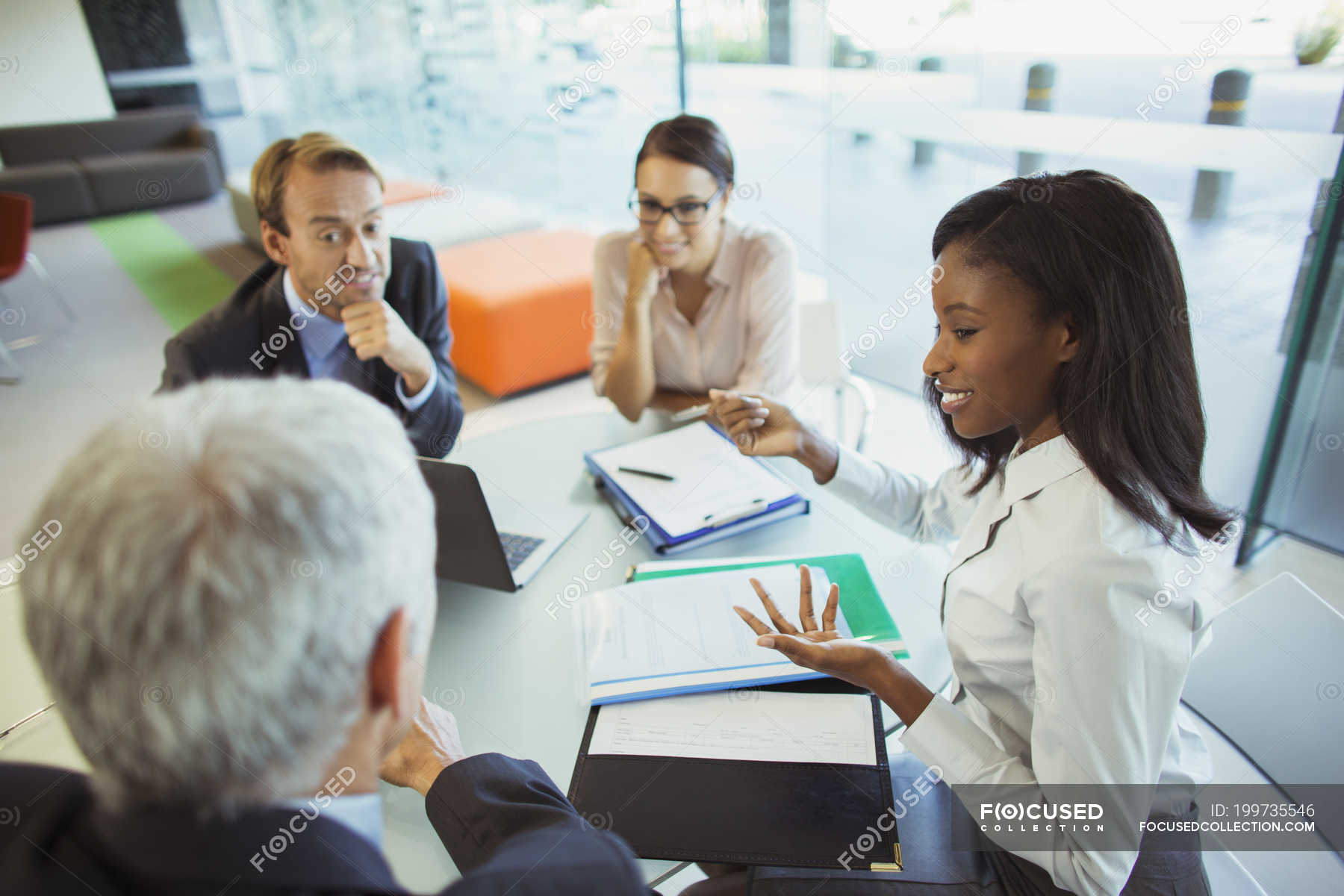 Business people talking at table in office building — women, partners -  Stock Photo | #199735546