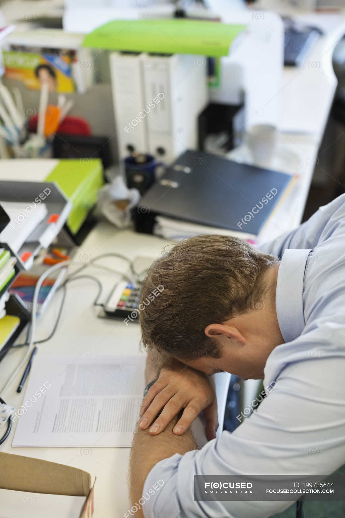 Businessman resting head on desk at modern office — Arms Crossed, sitting -  Stock Photo | #199735644