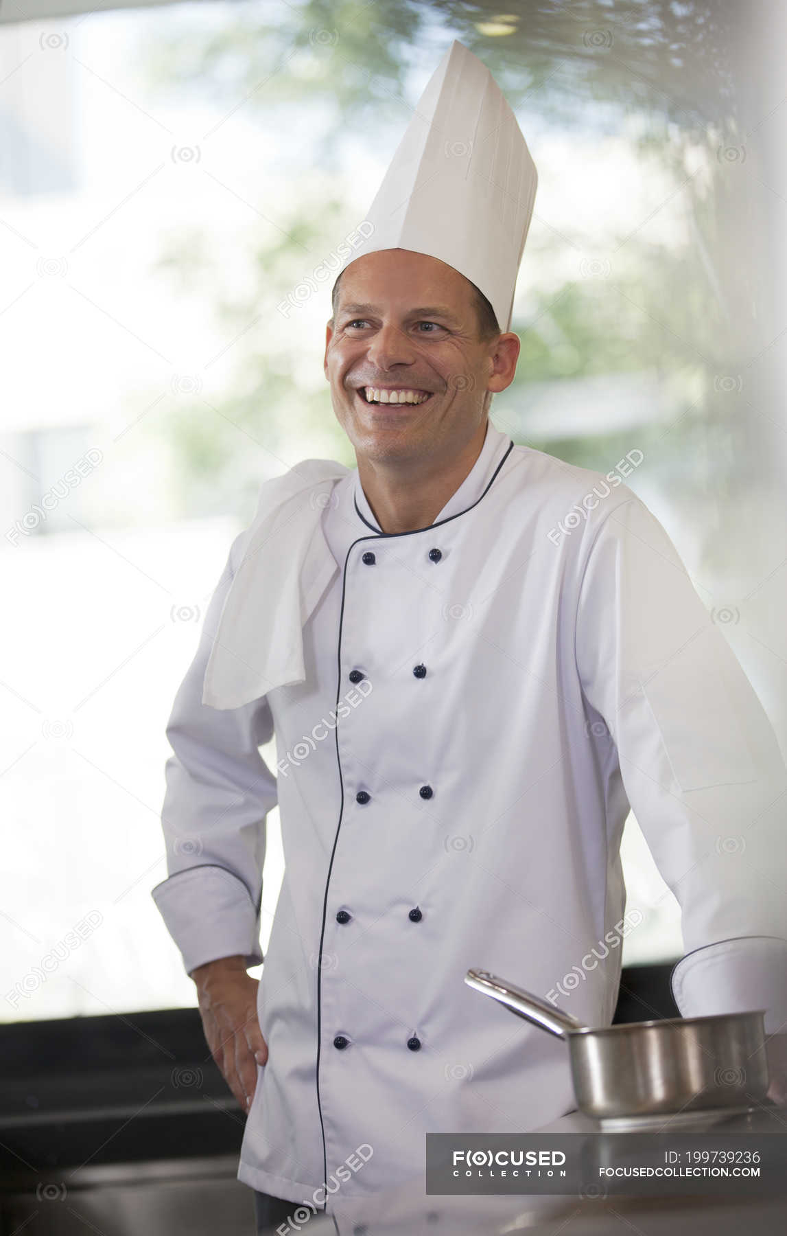 Chef smiling in restaurant kitchen — industry, Food And Drink Industry