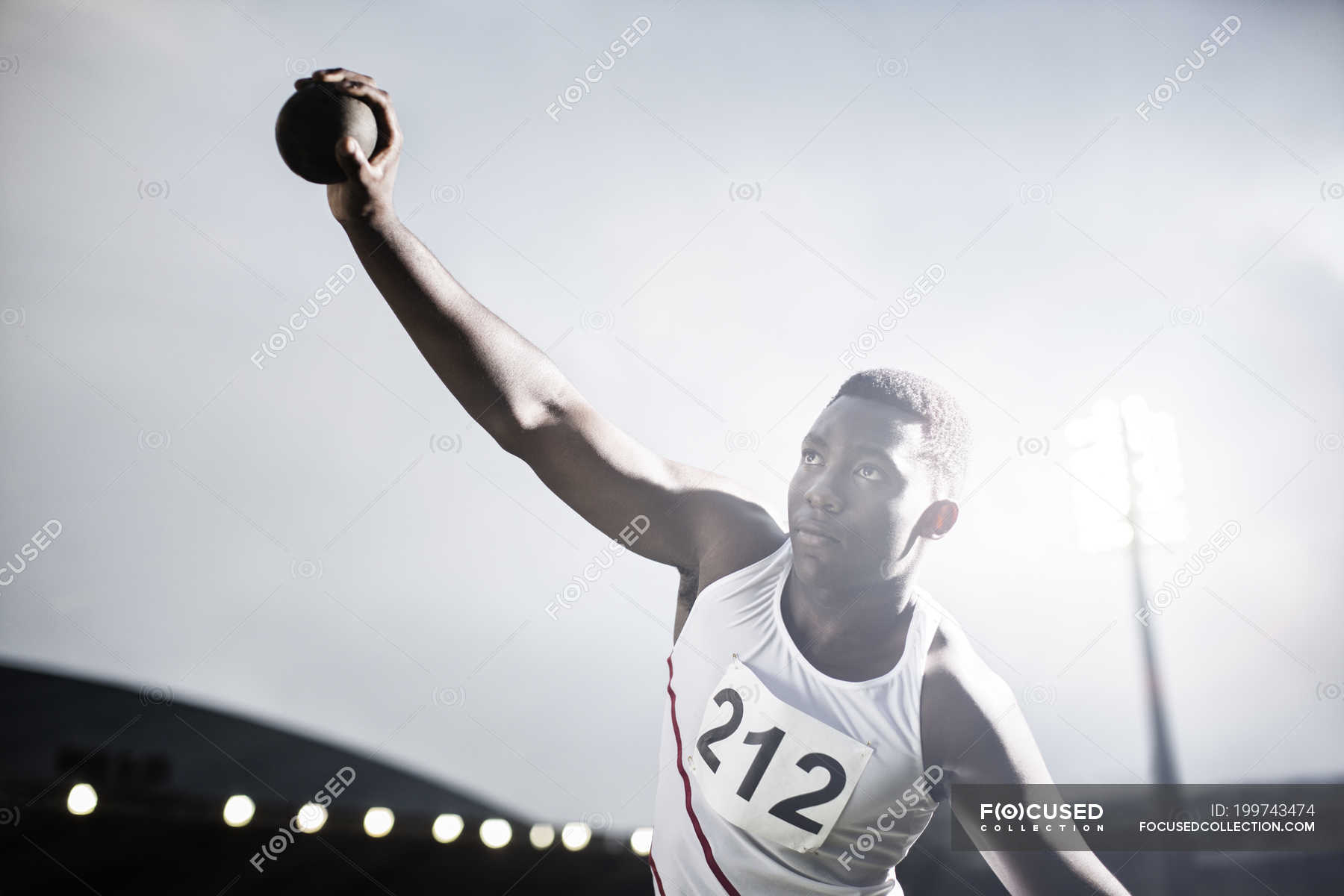 Track and field athlete throwing shot put — standing, african ethnicity ...