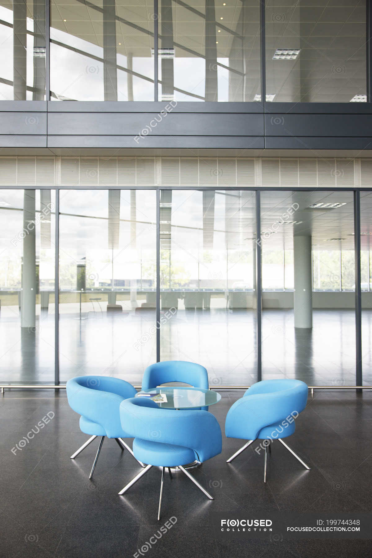 Chairs and table in office lobby area — real estate, workplace Stock Photo 199744348