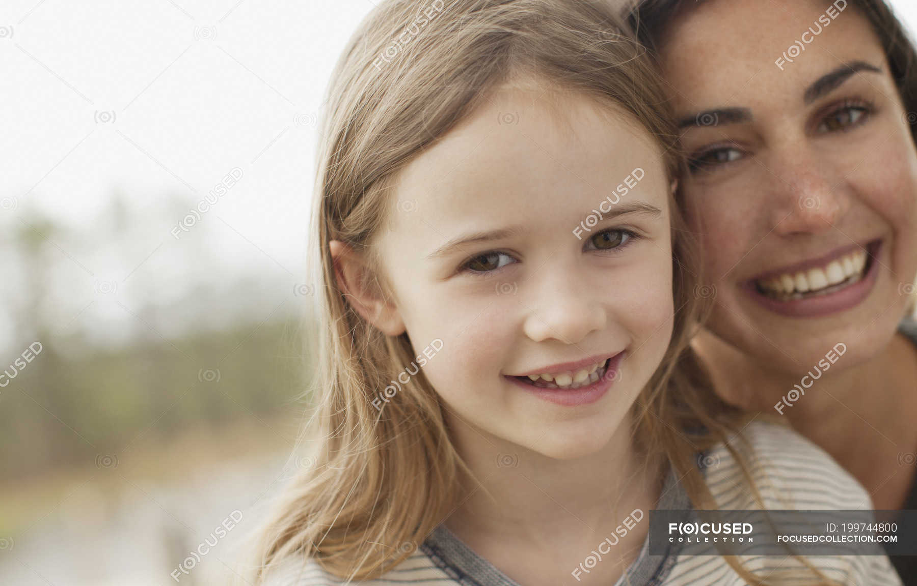 Close Up Portrait Of Smiling Mother And Daughter — Togetherness Head