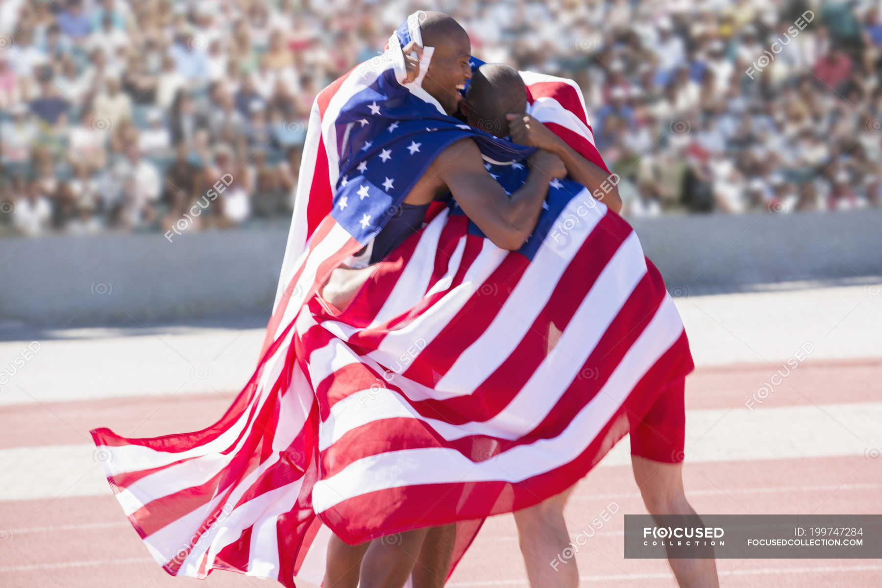 track-and-field-athletes-wrapped-in-american-flag-on-track-bonding