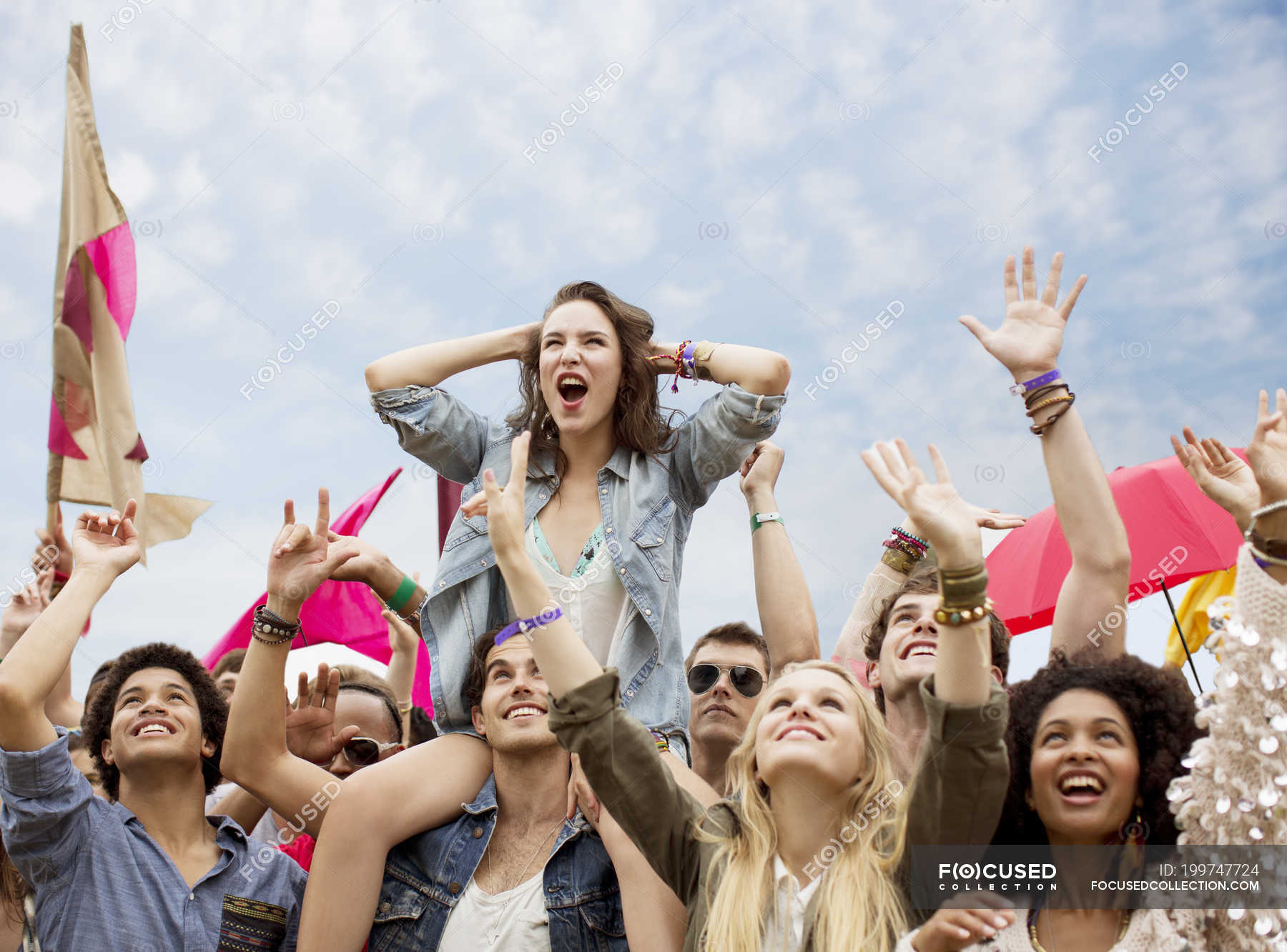 Cheering woman on man shoulders at music festival — sitting, head and  shoulders - Stock Photo | #199747724