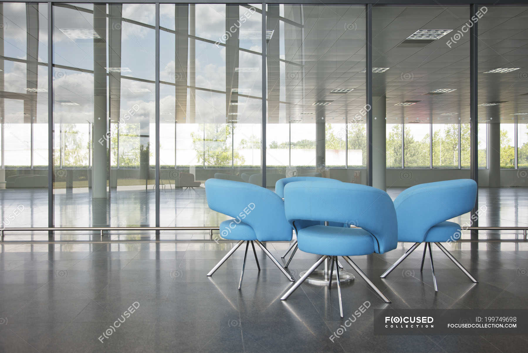 Chairs and table in office lobby area — reflection, photography Stock Photo 199749698