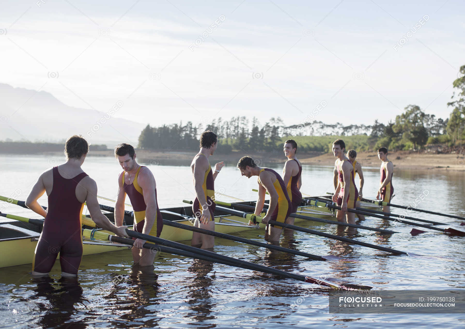 Rowing team placing boat on lake — teammate, outdoors Stock Photo 199750138