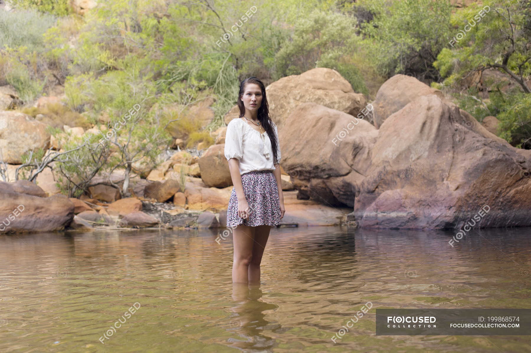 Portrait of woman wading in river — pool, travel - Stock Photo | #199868574