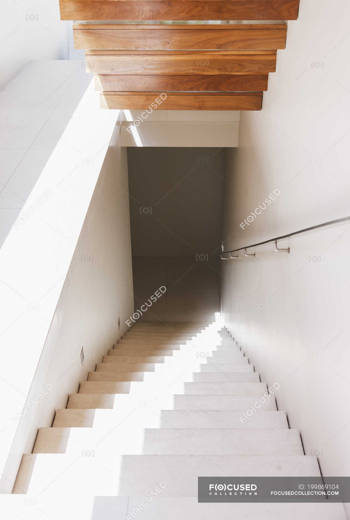 Light shining down staircase in modern house — vertical, sunny - Stock