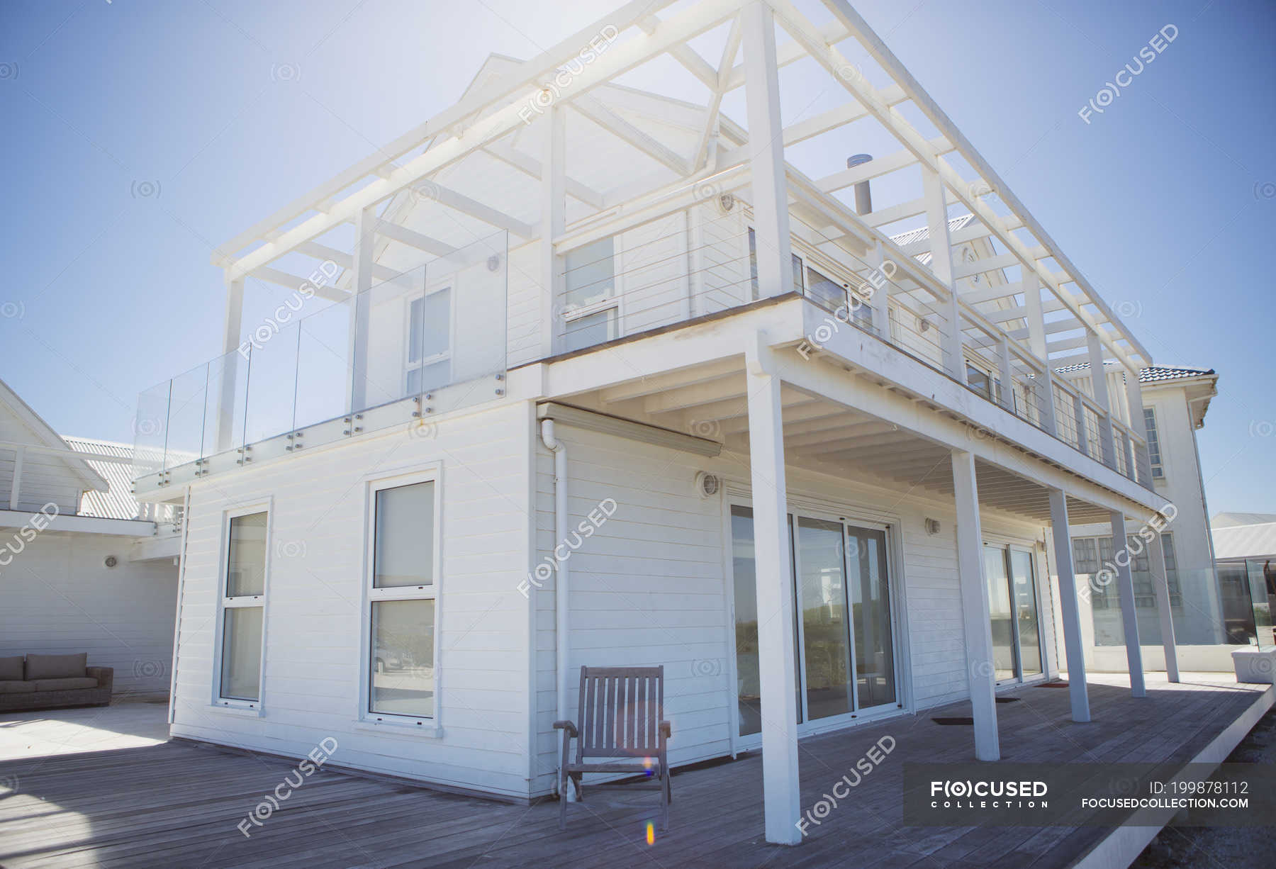 Deck and balcony on white beach house — daytime, photography - Stock