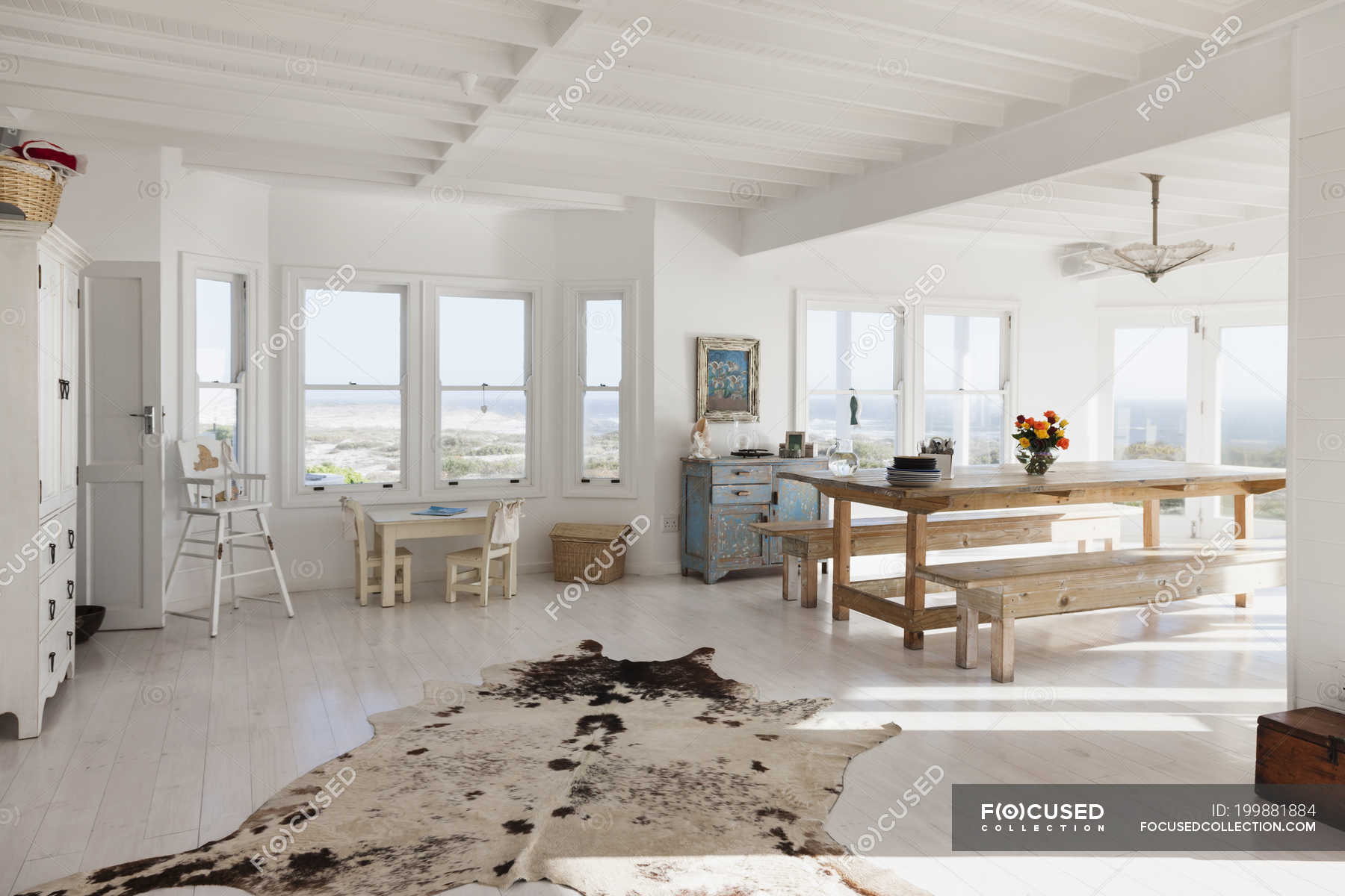 Animal skin rug in sunny dining room — wood, scenic view - Stock Photo | #199881884 Animal skin rug in sunny dining room — wood, scenic view - Stock Photo | #199881884