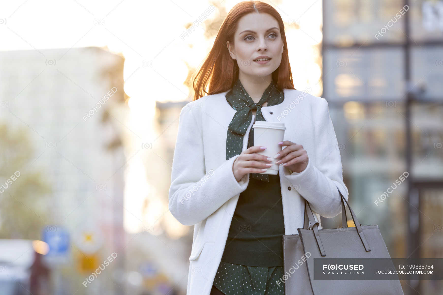 Businesswoman walking with coffee in city — coffee cup, style Stock