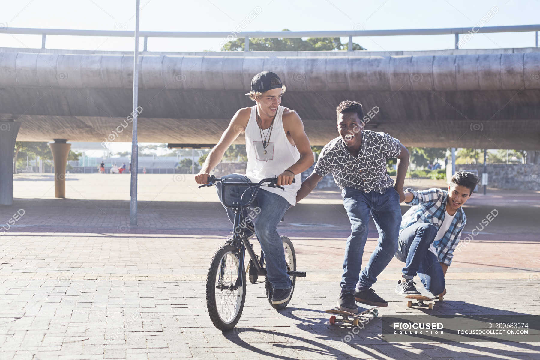 Riding boys. Teens Ride a BMX. David Ride his Bicycle while Kevin was Skateboarding.