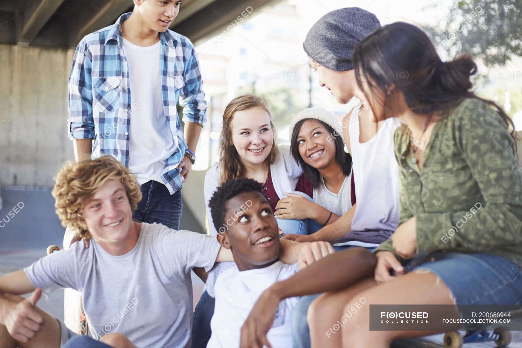 teenage-friends-hanging-out-talking-at-skate-park-togetherness-asian