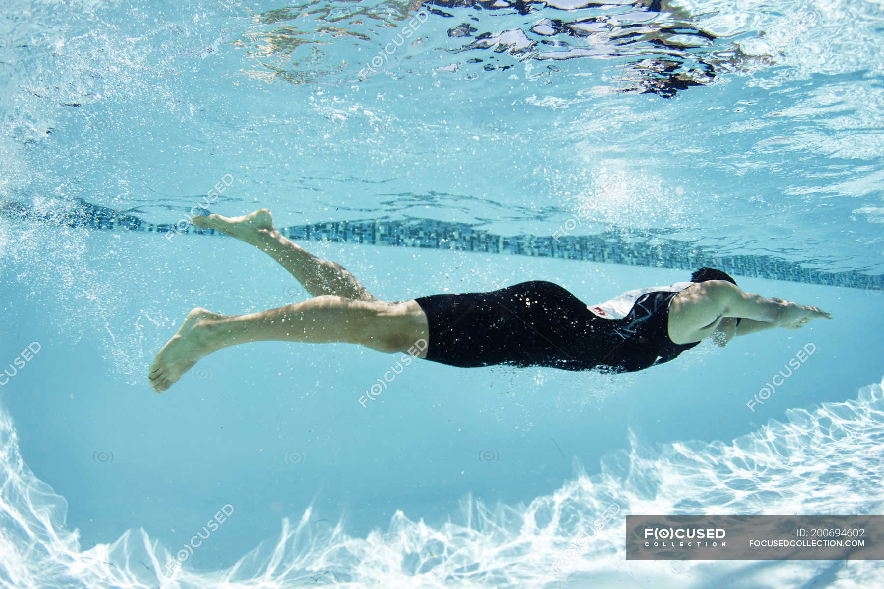 Male Swimmer Athlete Swimming Underwater In Swimming Pool — Training