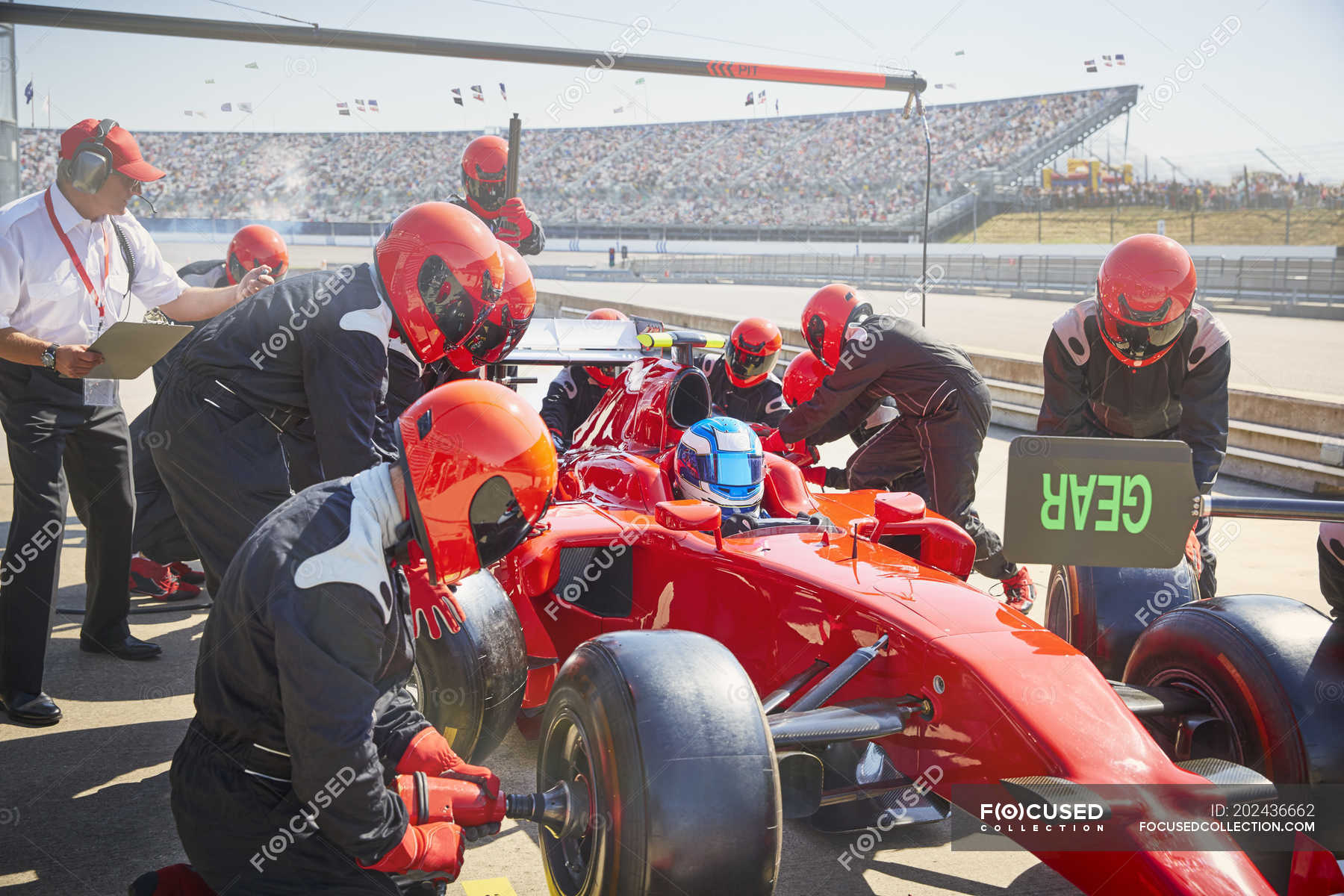 pit-crew-replacing-tires-on-formula-one-race-car-in-pit-lane-practice