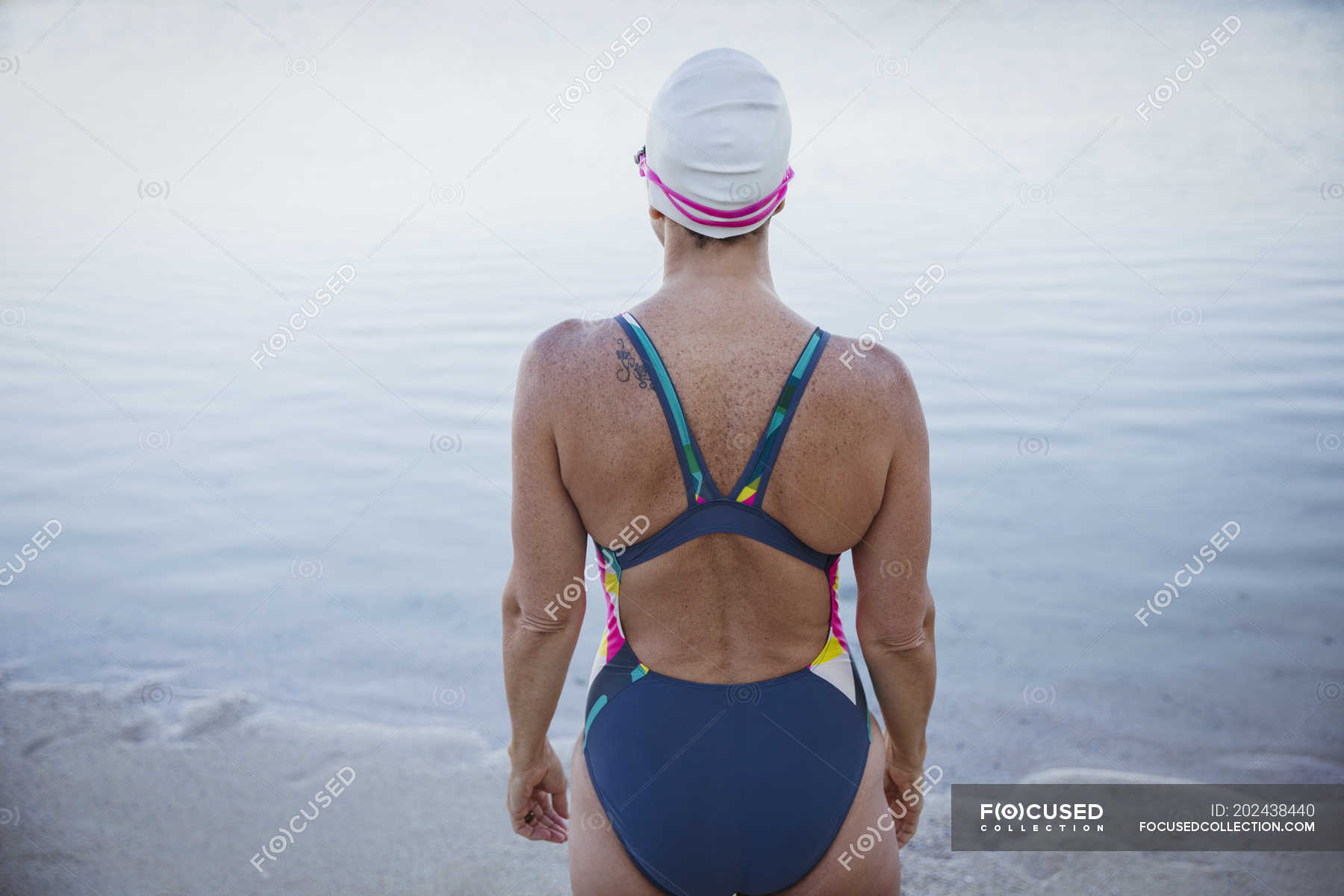 Rear View Female Swimmer At Ocean Leisure Daylight Stock Photo