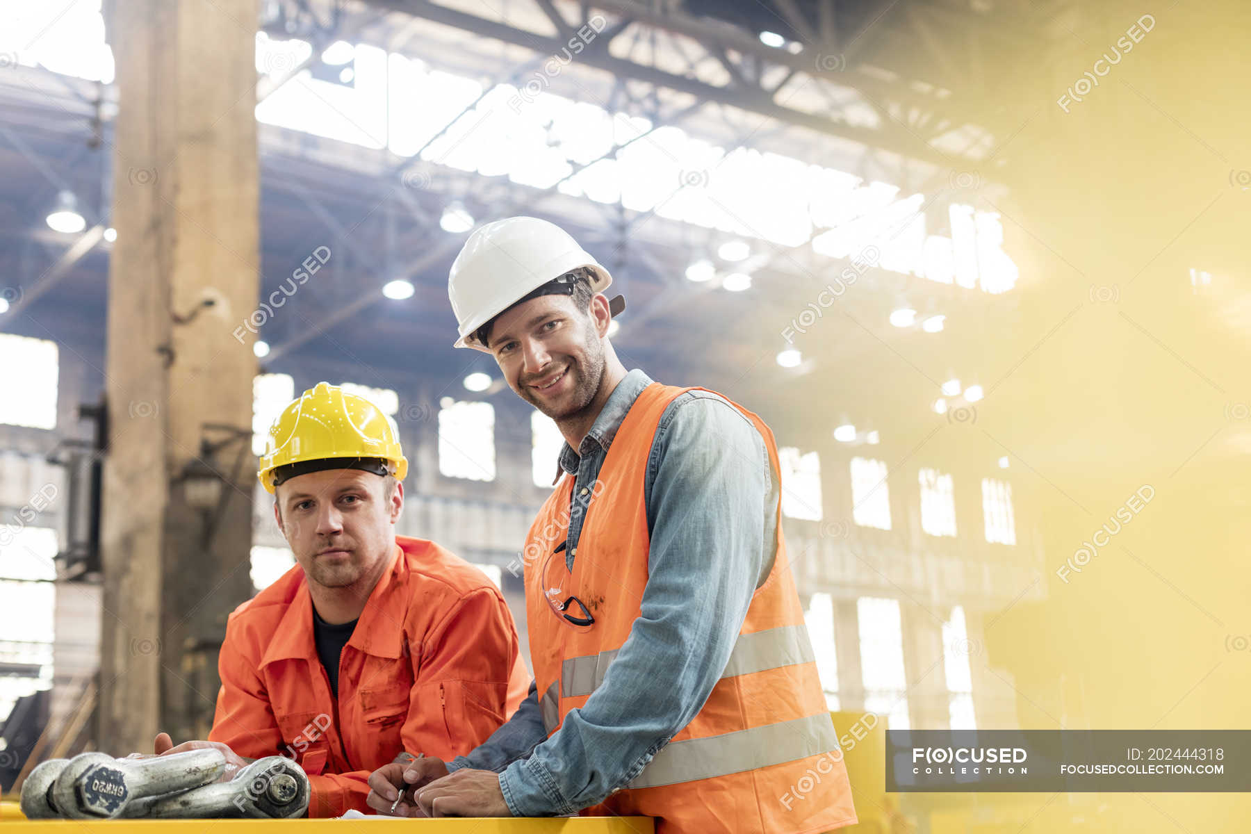 portrait-confident-steel-factory-workers-in-factory-low-angle-view