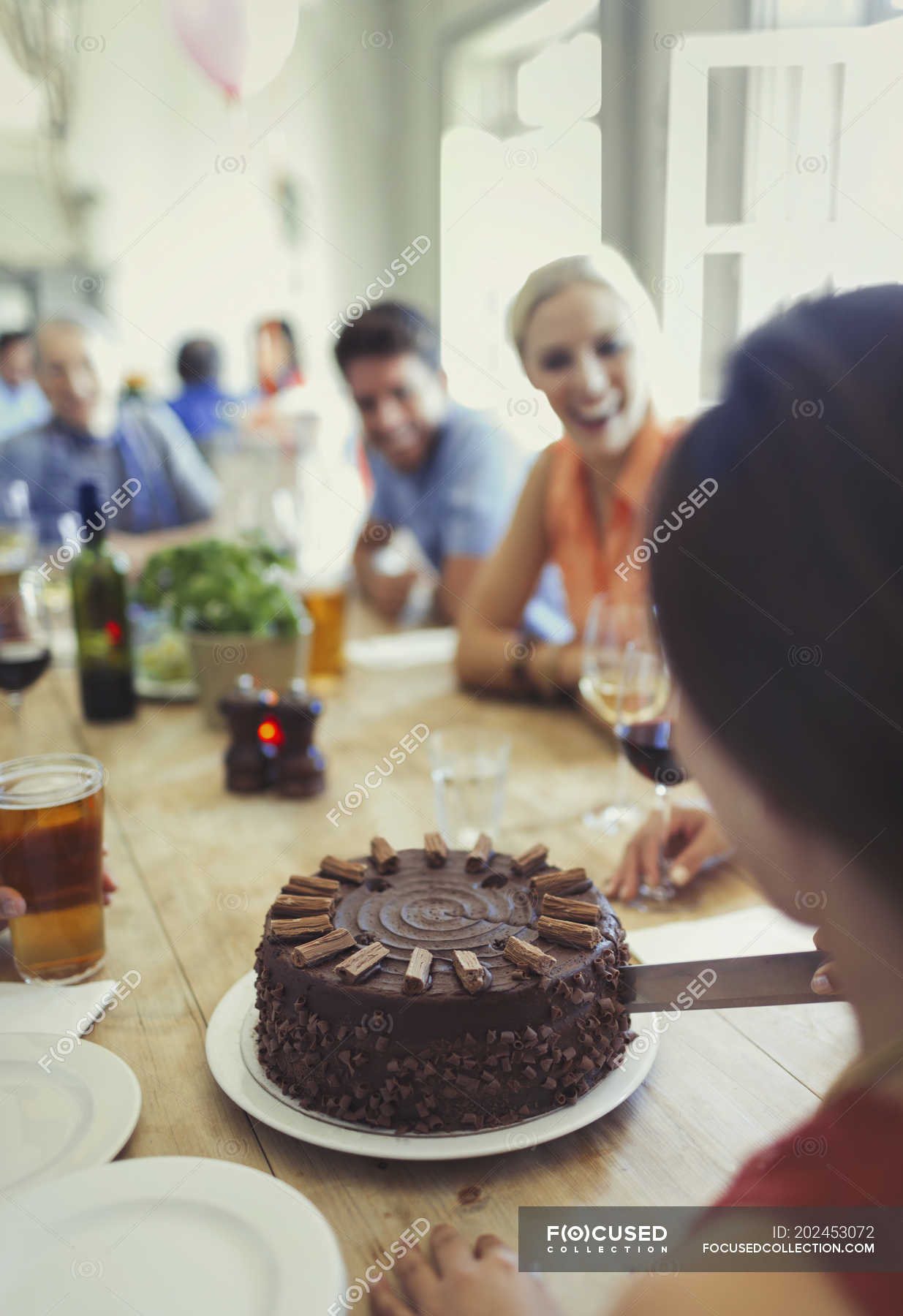 Black girl cutting cake at birthday party Stock Photo | Adobe Stock