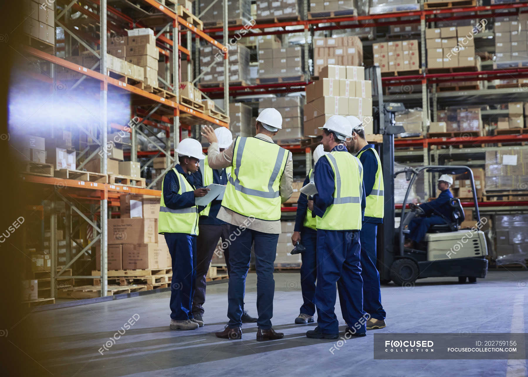 manager-and-workers-meeting-in-distribution-warehouse-togetherness