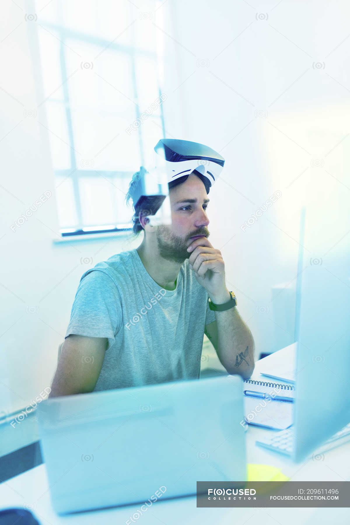 Focused computer programmer programming virtual reality simulator ...