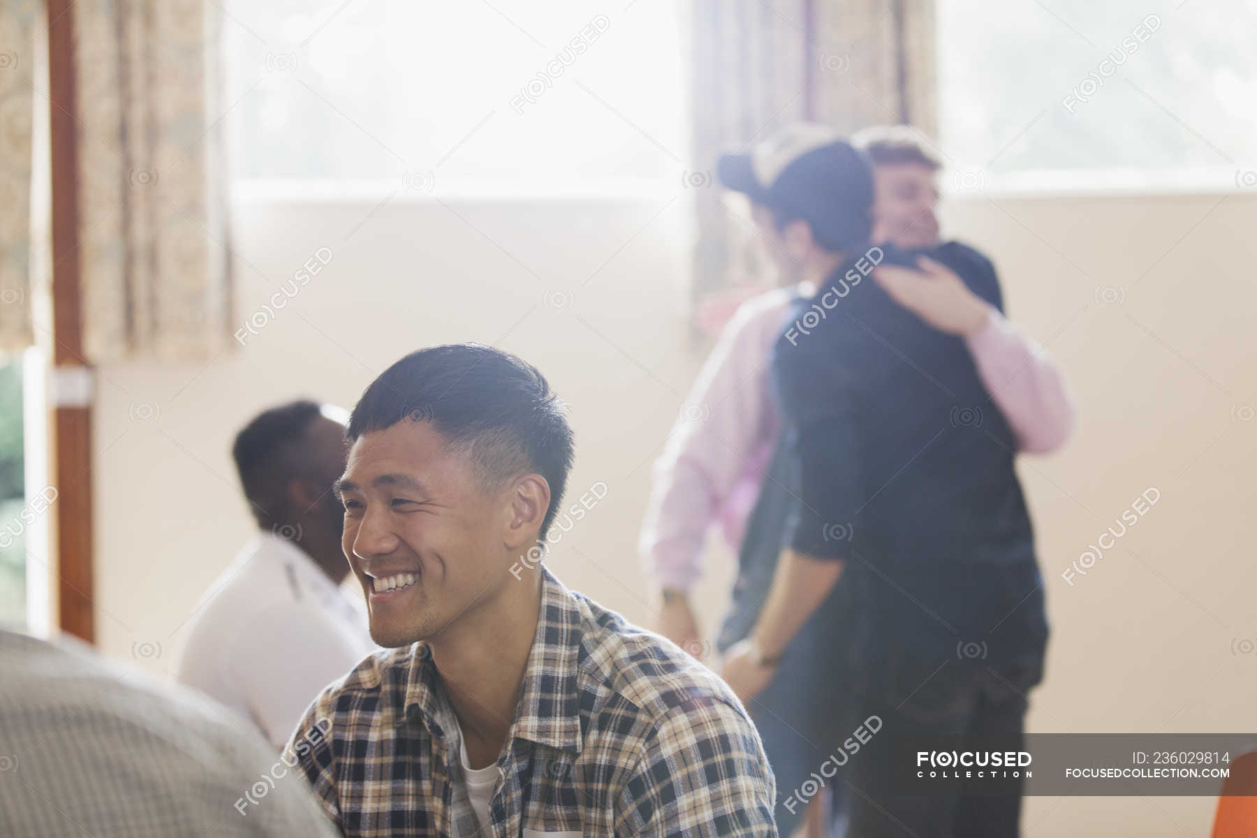 Smiling man enjoying group therapy — asian ethnicity, toothy smile ...