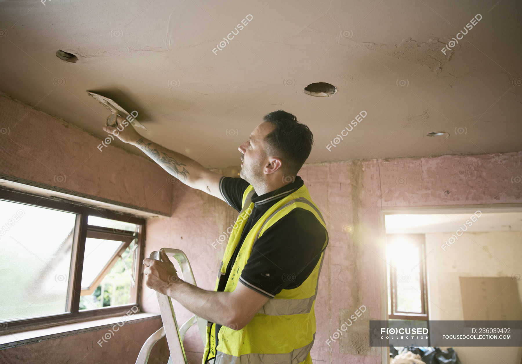 Construction Worker Plastering Ceiling In House Equipment Construction Worker Plastering Ceiling