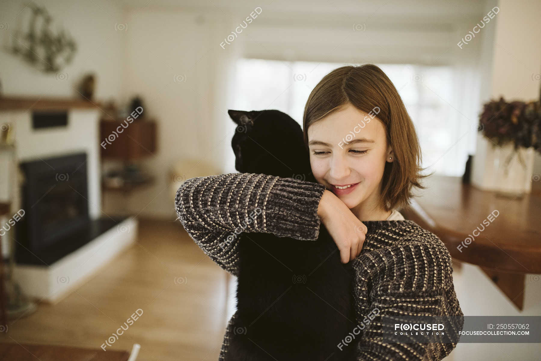 Affectionate girl holding black cat — Domestic Life, caucasian