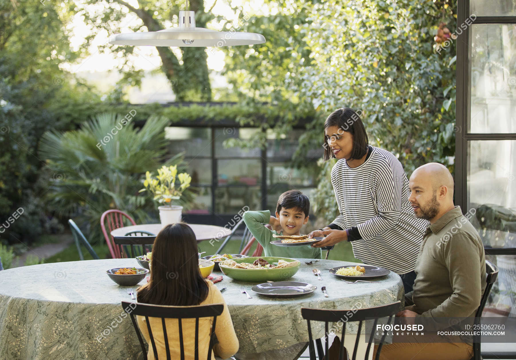 Family eating lunch at dining table — childhood, meal Stock Photo