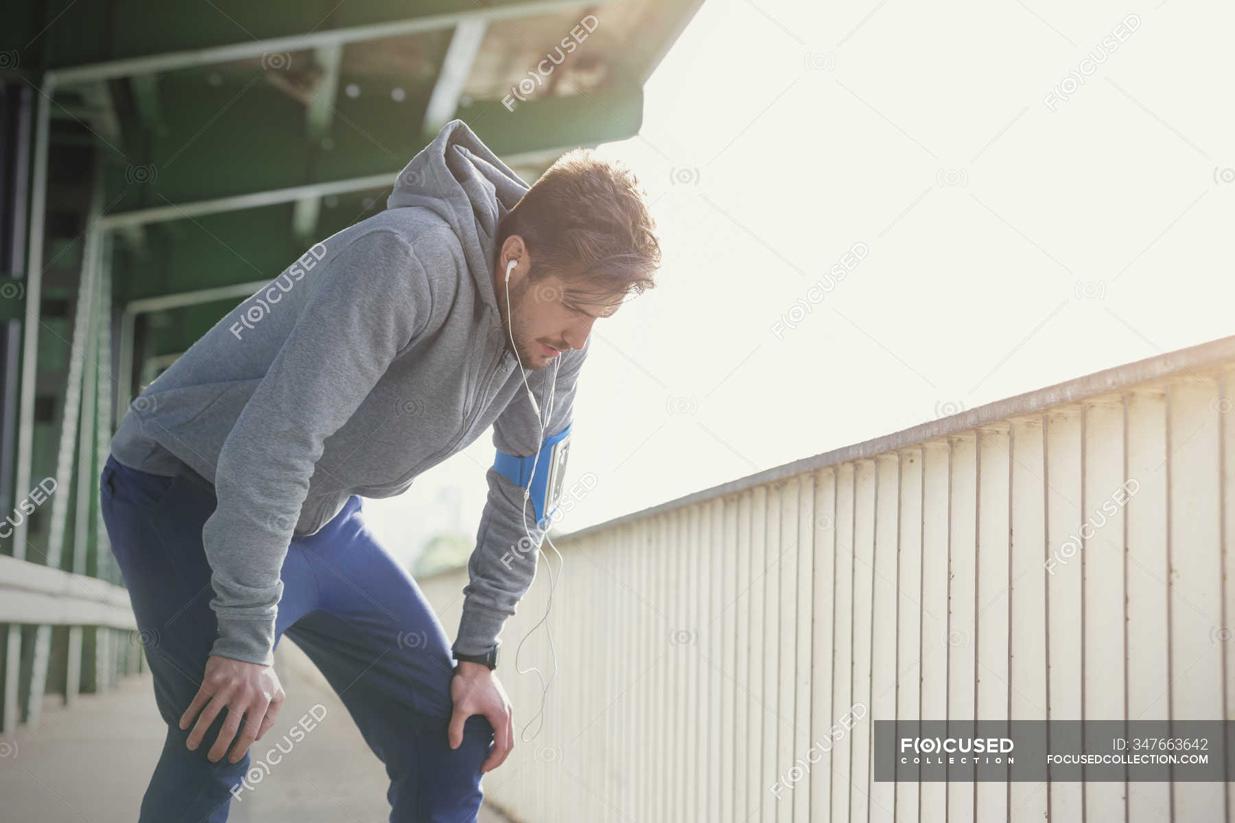 Tired male runner resting hands on knees — Cooling Down, athletic ...