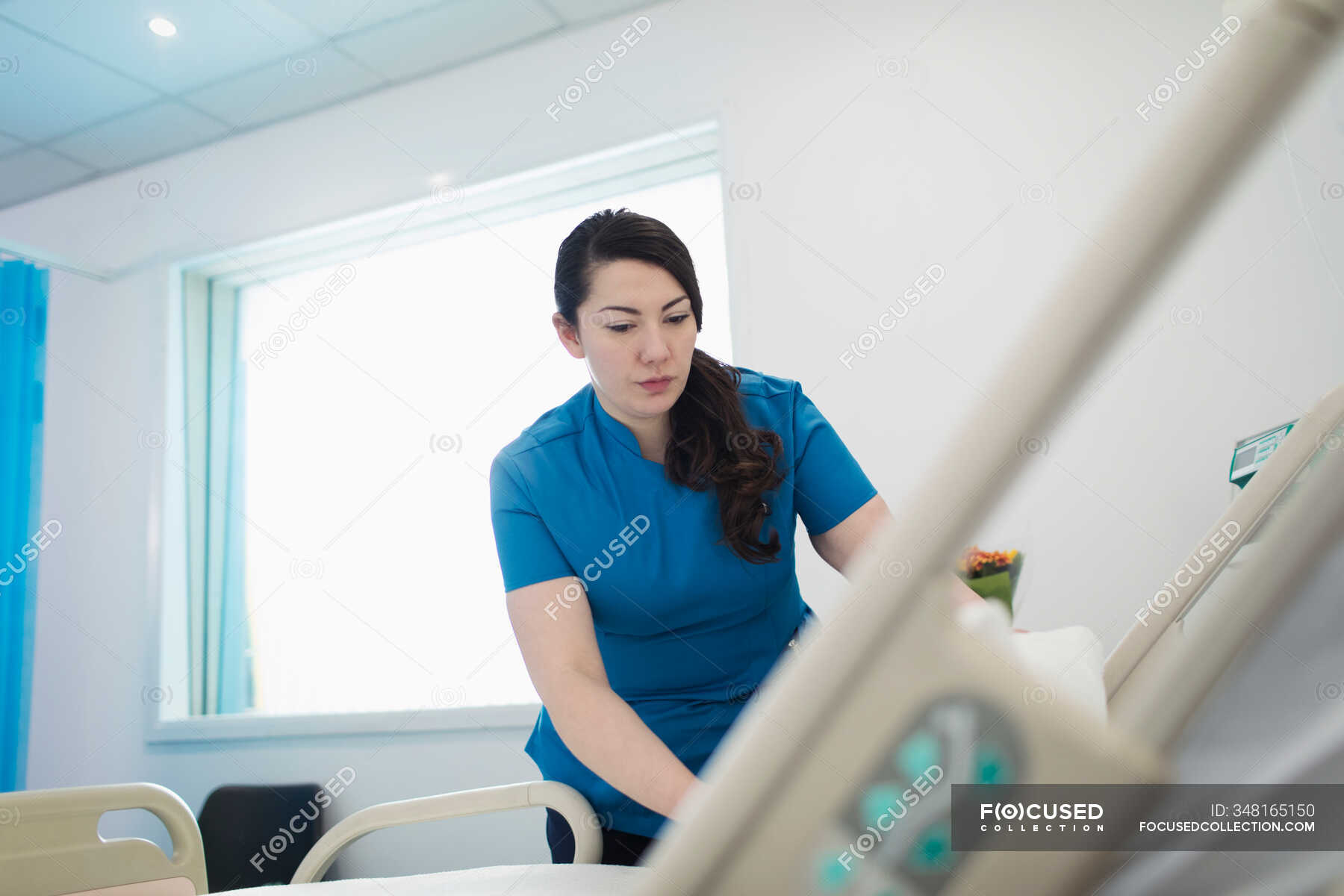 Female nurse making hospital bed — people, Bending - Stock Photo ...