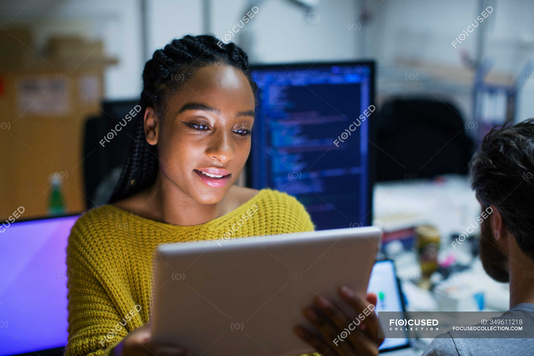 Female computer programmer using digital tablet in office — indoors