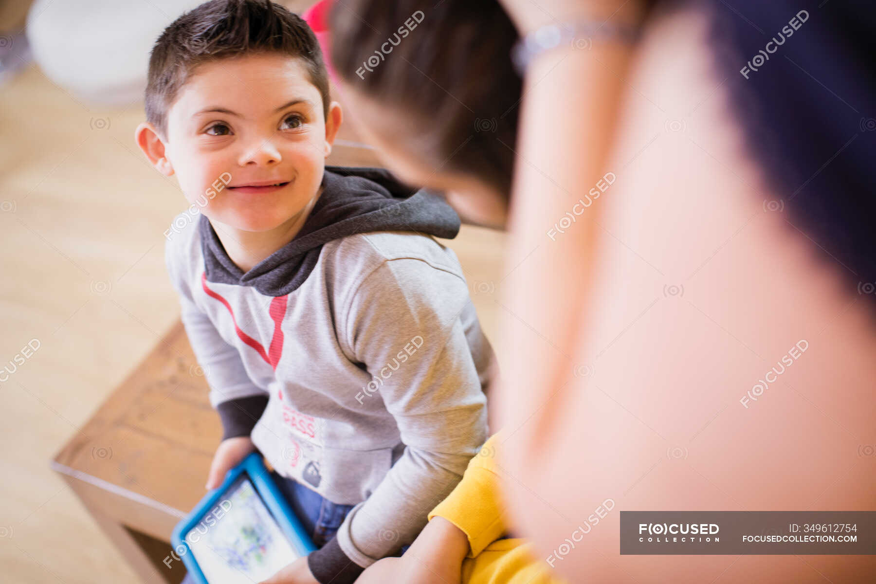 Smiling boy with Down Syndrome — internet, mother - Stock Photo