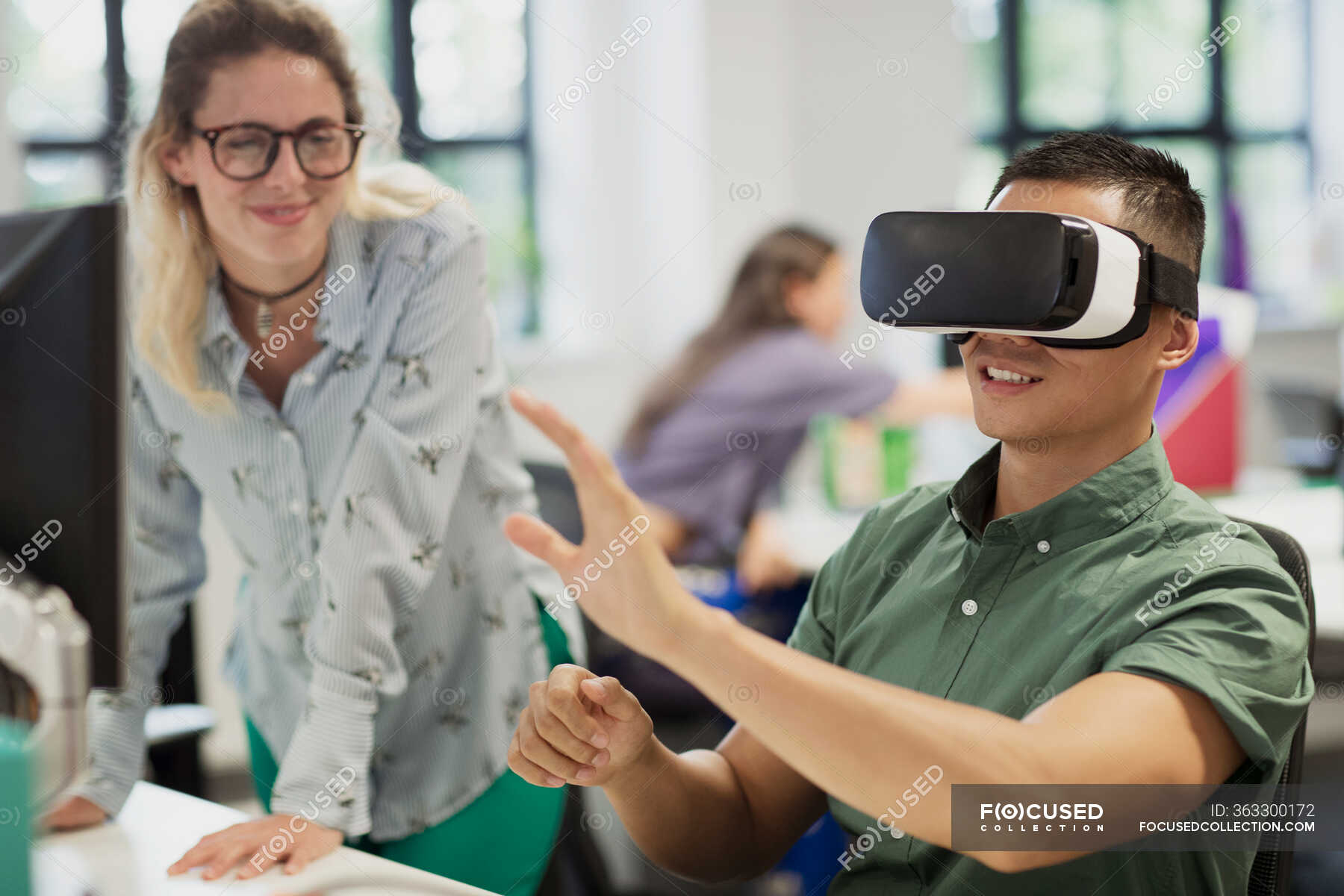 Computer programmers testing virtual reality simulator glasses in ...