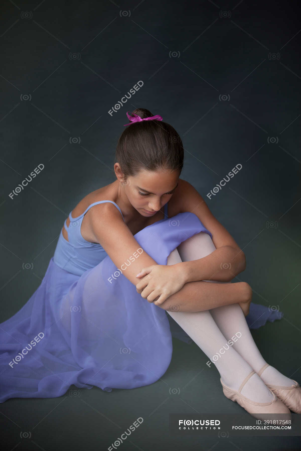 Ballerina hugging knees in studio — skill, daydreaming - Stock Photo ...