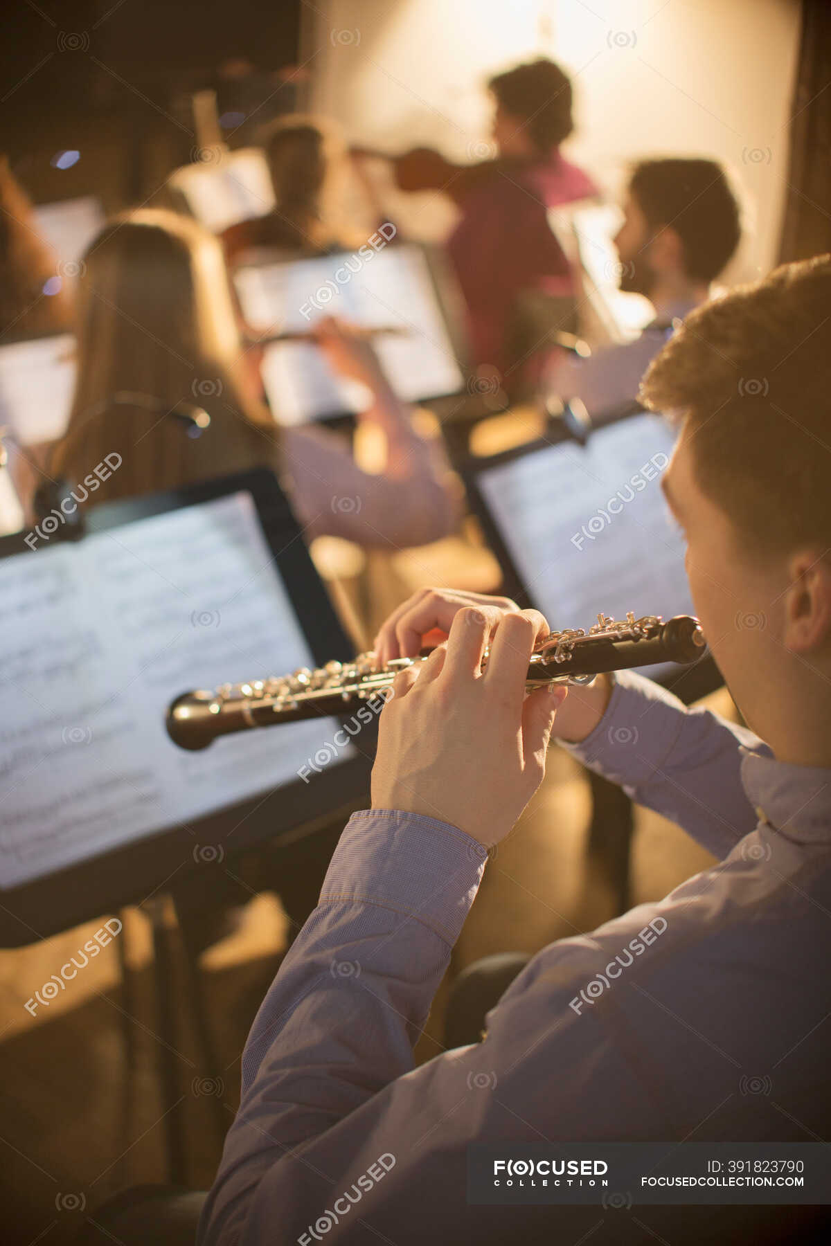 Oboist performing in orchestra — vertical, Young Men - Stock Photo ...