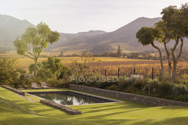 Landscape view of fields and mountains behind swimming pool — Stock Photo