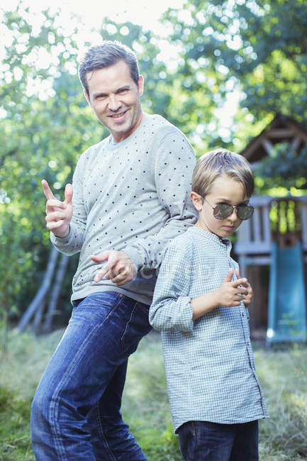 Father and son gesturing outdoors — Stock Photo