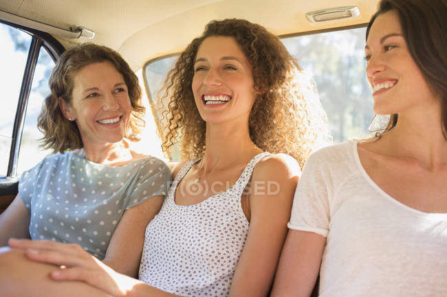 Three Women Sitting In Car Backseat Together Vehicle Interior