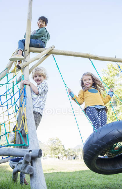 Niños jugando en la estructura del juego - foto de stock
