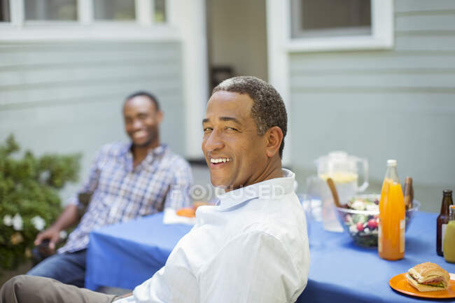 Portrait of smiling senior man at barbecue — Stock Photo