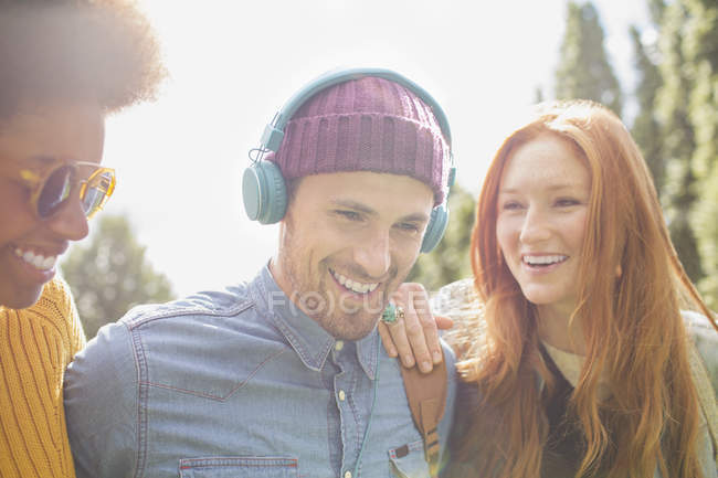 Happy young friends walking together outdoors — Stock Photo