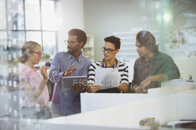 Creative business people with digital tablet planning, talking in office — Stock Photo