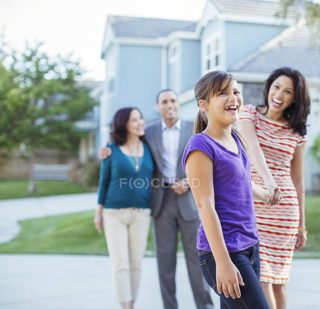 Multi-generation family walking outside house — Stock Photo