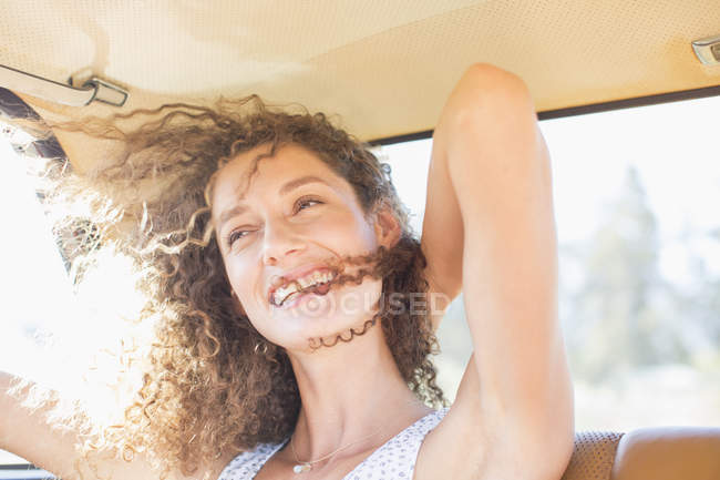 Woman being windswept from window breeze — Stock Photo