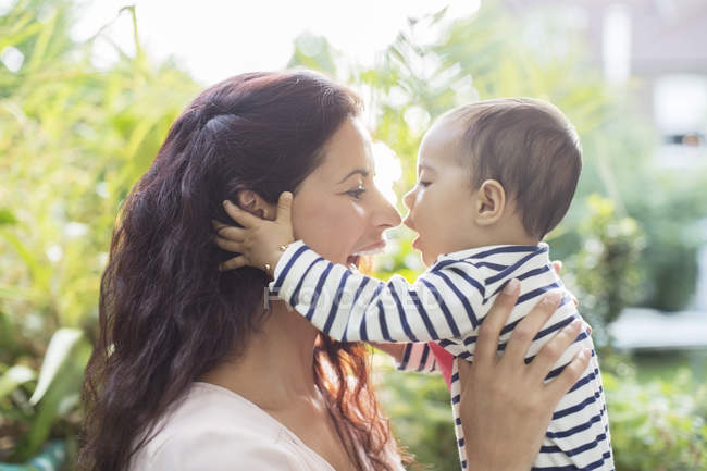 Mother holding baby girl outdoors — Stock Photo